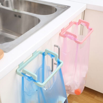 This colorful, plastic, Attach-A-Trash hanging trash bag holder is designed to easily hang over kitchen cabinet doors for convenient waste disposal